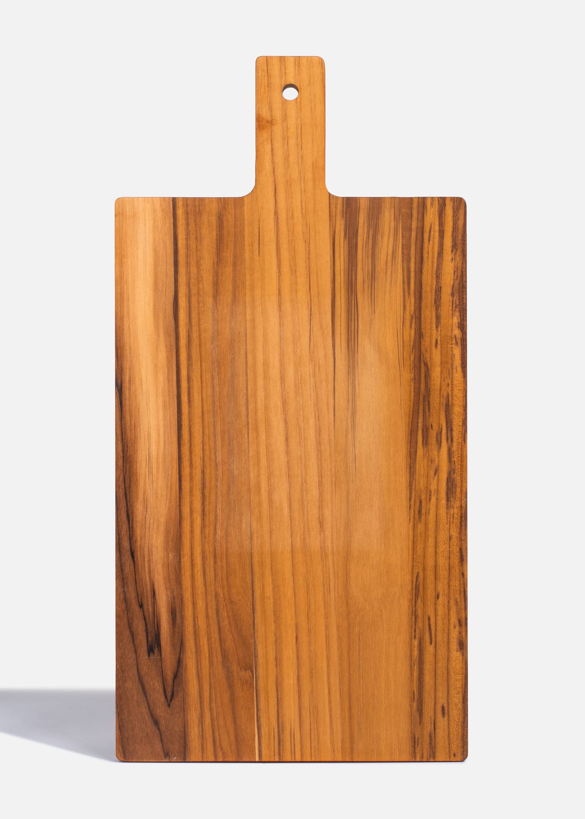 Reverso de tabla de madera natural para cortar y servir carnes.